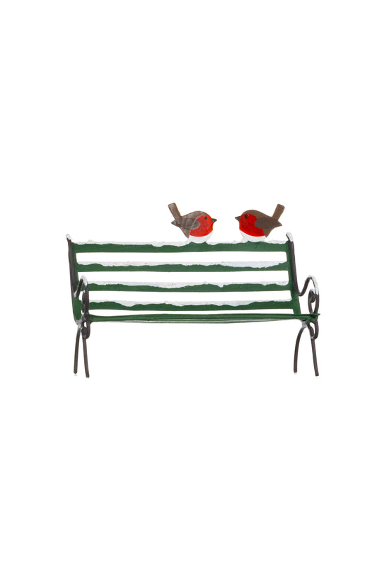 Robins on a snowy park bench