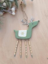 Wooden reindeer with snow flake decoration